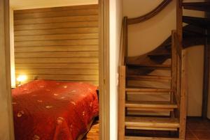 a bedroom with a bunk bed and a ladder at Karhunvartija 11 Visit Levi in Sirkka