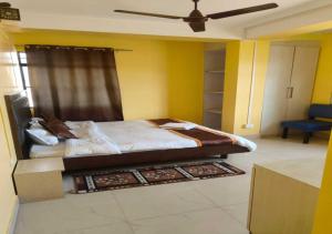 a bedroom with a bed and a ceiling fan at Golf View Residency in Shillong