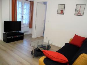 a living room with a couch and a glass table at Tourelle in Gagny