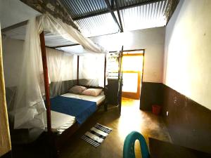 a bedroom with two bunk beds and a window at HOTSPOT inn - Malindi in Malindi