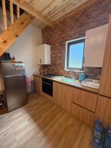 a kitchen with a stainless steel refrigerator and a window at Tsemi Aura in Tsemi