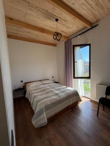 a bedroom with a large bed and a large window at Tsemi Aura in Tsemi