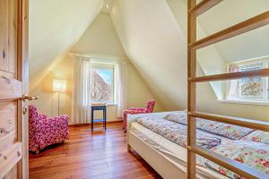a bedroom with a bunk bed and a window at Haus Bei Der Kirche in Oland