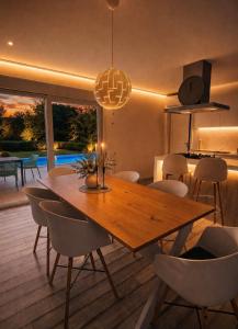 a dining room with a wooden table and chairs at Villa Heaven Green in Pazin