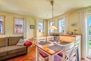 a living room with a table and a couch at Haus Bei Der Kirche in Oland +66 photos