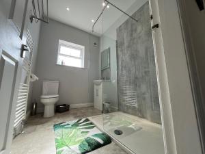 a bathroom with a shower with a glass door at Durham 3 Bedroom House With Parking in Durham