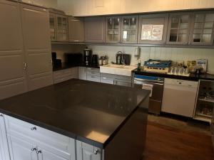 a kitchen with a large black counter top in it at Fanaseter in Bergen