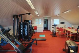 a room with a gym with a table and chairs at Fanaseter in Bergen