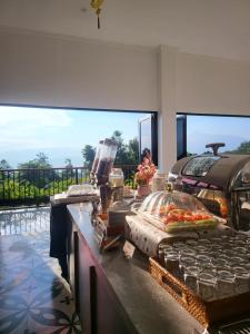 a kitchen with a counter with food on it at Moya Villa & Resto in Cihideung