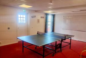 a ping pong table in the middle of a room at Fanaseter in Bergen