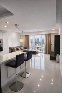 a kitchen and living room with a table and chairs at Seafront-Top Location-Close To Shops & Restaurants in St. Julianʼs