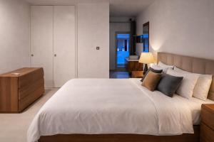 a bedroom with a large white bed with pillows at Seafront-Top Location-Close To Shops & Restaurants in St. Julianʼs