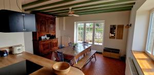 a kitchen with a table and a dining room at A La Bruyère in Saint-Martin-du-Lac