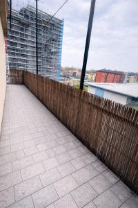 a wooden fence on a balcony of a building at Alessandro home in Rozzano