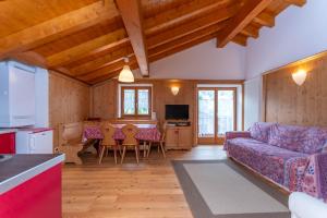 a living room with a couch and a table at El Feral - Mansarda in Selva di Cadore