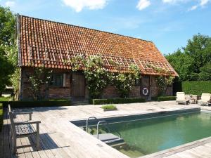 a house with a swimming pool in front of a building at Haus Quitte in Kühlungsborn