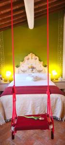 a bedroom with a bed with a red and white canopy at Dimora del Passaggio in Castiglion Fiorentino