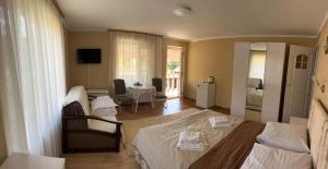 a bedroom with a bed and a living room at Vivat in Solochyn
