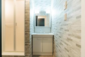 a bathroom with a sink and a mirror at T-square旭大前I in Asahikawa +34 photos