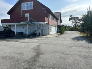 a house with a car parked in the driveway at Fanaseter in Bergen +1 photo