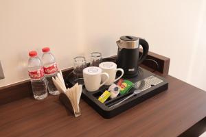 a tray with a coffee maker and drinks on a table at Hotel Sachin in Chas