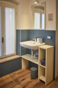 a bathroom with a sink and a mirror at B&Bee alla corte in Dossobuono