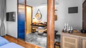a bathroom with a sink and a mirror at PURE Hotel Lijiang in Lijiang +105 photos