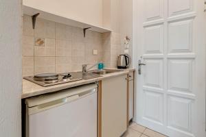 a kitchen with a sink and a counter top at Alexandros Apartments in Ipsos +18 photos