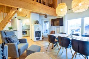 a kitchen and living room with a table and chairs at Alppitalo 3 as 3 in Tahkovuori