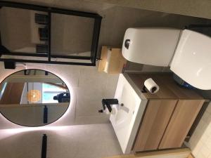 a small bathroom with a sink and a mirror at Alppitalo 3 as 3 in Tahkovuori +13 photos