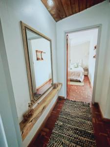 a hallway with a large mirror and a bedroom at Mienru House Self Catering Cottage in Riviersonderend +14 photos