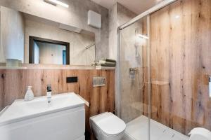 a bathroom with a toilet and a glass shower at Chalet Seewald - Tiny House in Seewald +14 photos