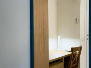 a room with a desk and a table with a lamp at VICO 11 Gaeta - UN LETTO IDEALE in Gaeta +25 photos