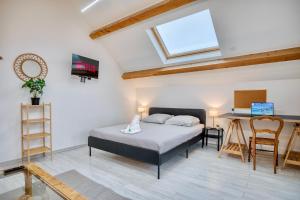 a bedroom with a bed and a desk and a window at COLIVING - bedroom Salon & TV in Saint-Jean-de-Gonville