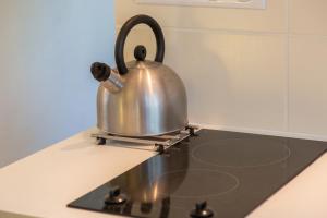 a tea kettle sitting on top of a stove at Kervégant Chambres D'hôtes in Riec-sur-Bélon