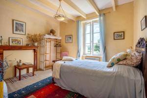a bedroom with a bed and a fireplace at Kervégant Chambres D'hôtes in Riec-sur-Bélon