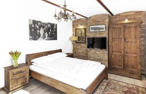 a bedroom with a bed and a brick wall at Ułańska Zagroda in Człopa +69 photos