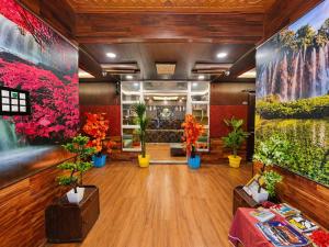 a flower shop with potted plants and paintings on the walls at Pine View Resort in Gulmarg