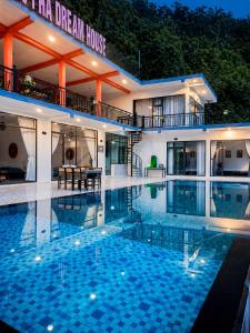 a large swimming pool in front of a building at Sam Hotel Lào Cai in Pu Chu Chay