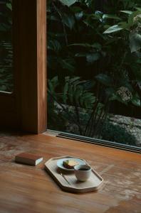 a plate of food and a cup on a table at 宿屋 余白丨yadoya yohaku in Wakayama