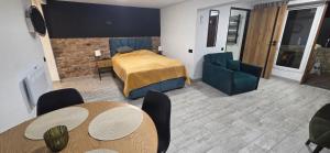 a room with a bed and two tables and chairs at Apartament Nova Kamienica - Studio in Łagów