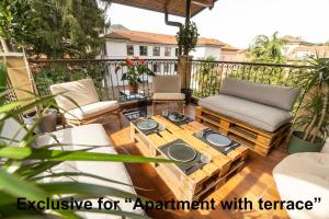 an apartment patio with a coffee table and chairs at Casa Anzi in Como