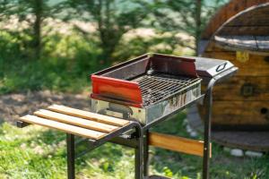a bbq grill with a bench next to it at "Olive & Bloom" entire vila with Pool & Private Parking in Berat