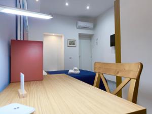a dining room with a table and a chair at VICO 11 Gaeta - UN LETTO IDEALE in Gaeta