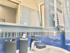 a bathroom with a sink and a mirror at VICO 11 Gaeta - UN LETTO IDEALE in Gaeta