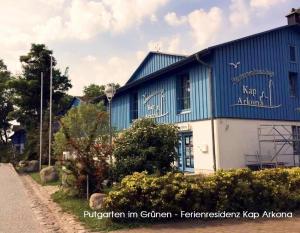 a blue and white building on the side of a road at Blinkfüer am Kap Arkona in Putgarten