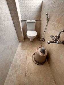 a small bathroom with a toilet and a shower at ADITI ROOMS in Tiruchirappalli