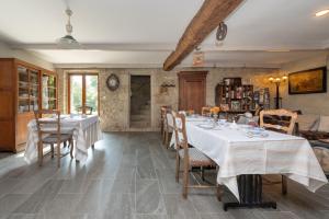 a dining room with two tables and chairs and a room at Maison D'hôtes De Calzac Moulin - in Le Gorvello