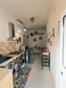 a kitchen with a counter and a table in it at Sea House in Taranto +6 photos