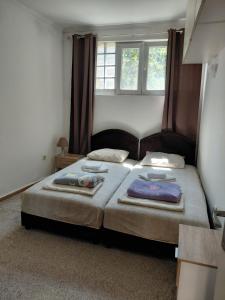 a bedroom with two beds with towels on them at Agica apartment in Škaljari